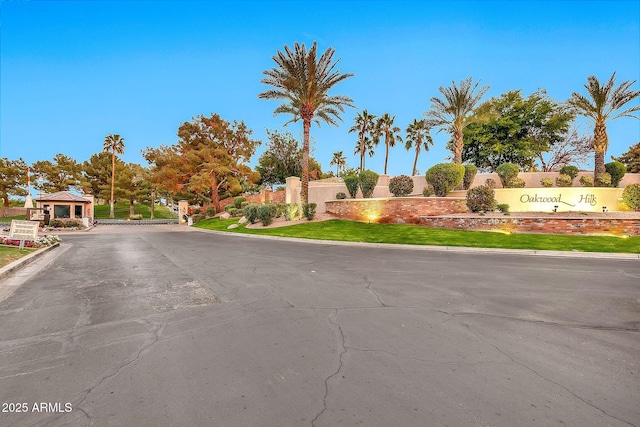 view of road featuring curbs and a gated entry