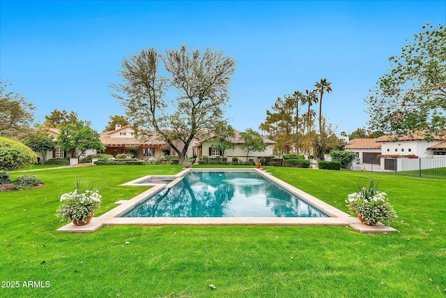pool featuring a lawn and fence