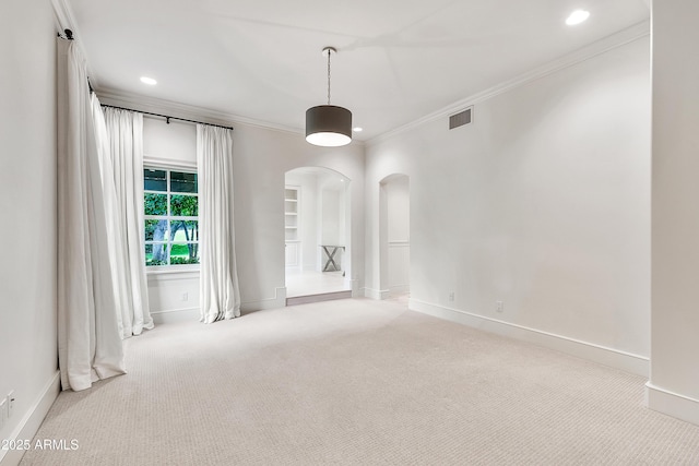 carpeted empty room with recessed lighting, baseboards, arched walkways, and ornamental molding