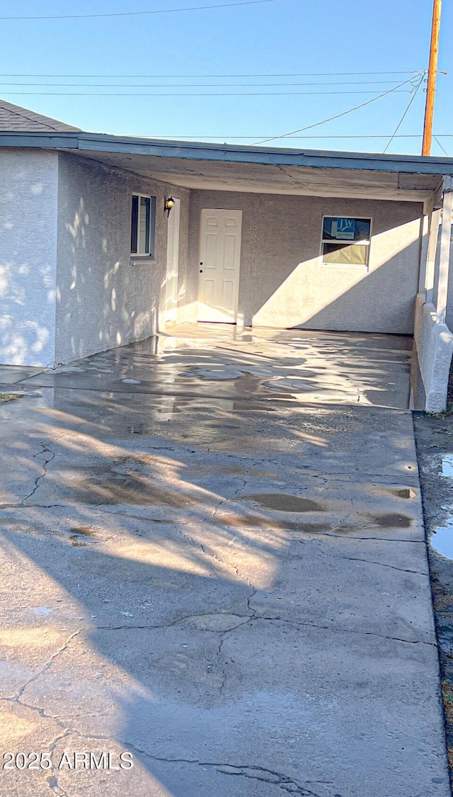 entrance to property featuring a patio area