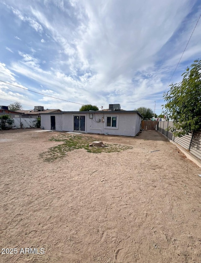 rear view of property featuring central AC