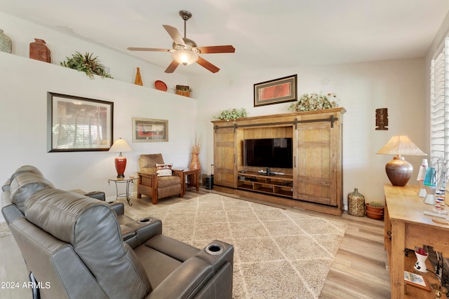 living room featuring ceiling fan and hardwood / wood-style floors