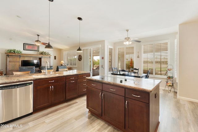 kitchen featuring ceiling fan, pendant lighting, dishwasher, a center island with sink, and light hardwood / wood-style flooring