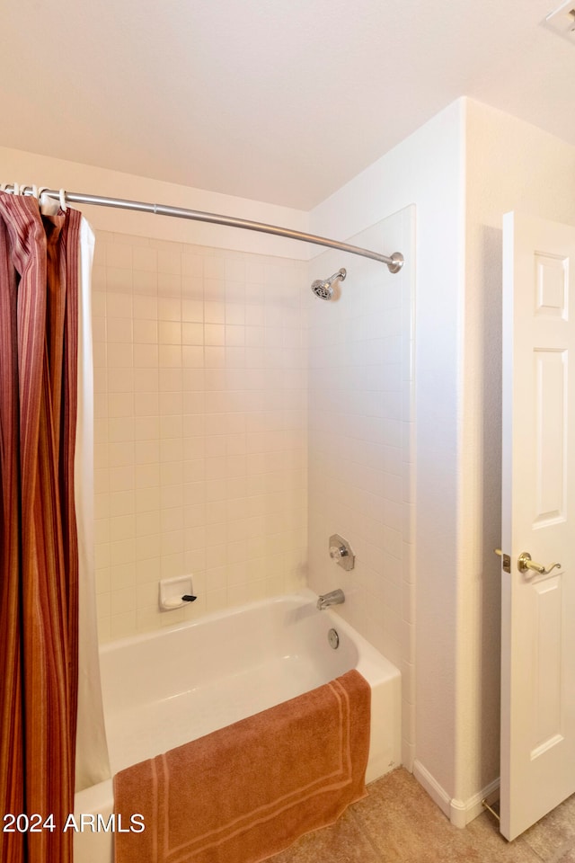 bathroom featuring tile patterned flooring and shower / bath combination with curtain