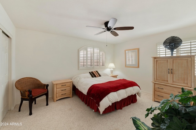 carpeted bedroom with multiple windows, a closet, and ceiling fan