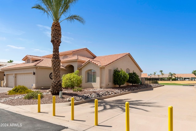 mediterranean / spanish-style home with a garage