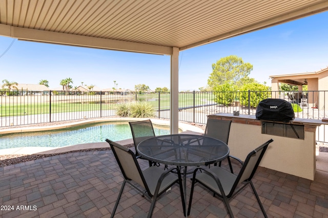 view of patio / terrace with a fenced in pool