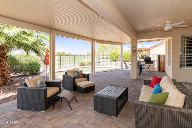 view of patio featuring an outdoor hangout area, a fenced in pool, and ceiling fan