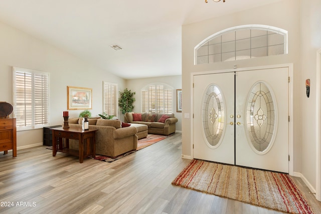 entryway featuring high vaulted ceiling and light wood-type flooring