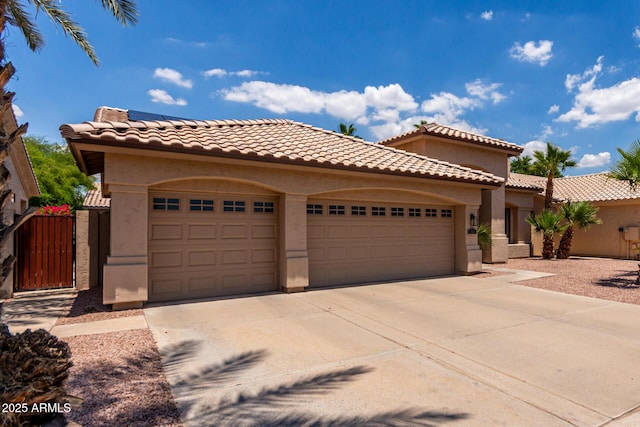 1884 E Stephens Dr, Tempe, AZ 85283 - mediterranean / spanish-style home featuring a garage, stucco siding, concrete driveway, a gate, and a tiled roof