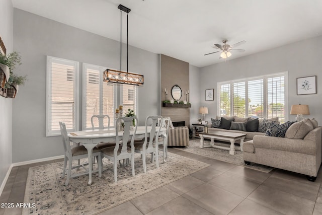 1884 E Stephens Dr, Tempe, AZ 85283 - dining room with a ceiling fan, a chandelier, baseboards, and a fireplace
