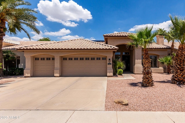 1884 E Stephens Dr, Tempe, AZ 85283 - mediterranean / spanish-style home featuring an attached garage, stucco siding, driveway, and a tile roof