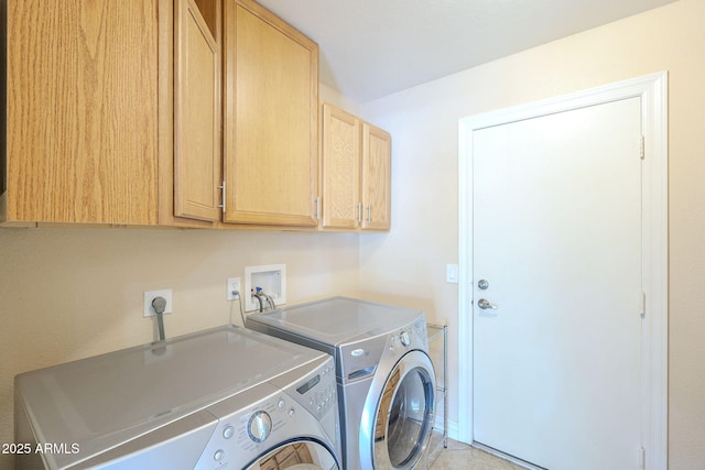 clothes washing area featuring cabinet space and independent washer and dryer