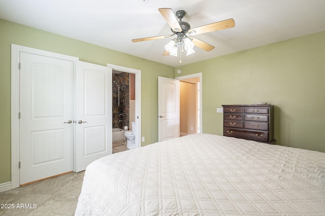 bedroom with ceiling fan and connected bathroom