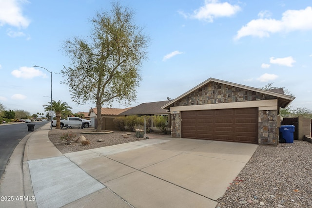 mid-century home featuring stone siding and concrete driveway