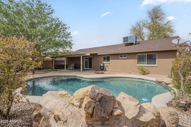 view of swimming pool with a patio area, a fenced in pool, fence, and central AC