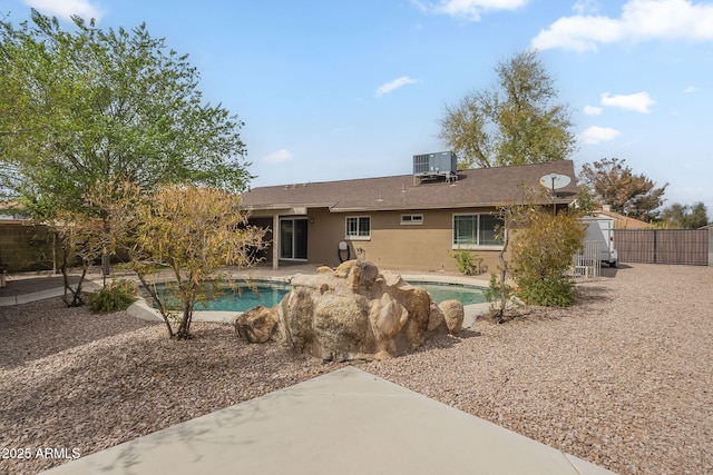 back of house featuring a gate, a patio area, fence, cooling unit, and an outdoor pool