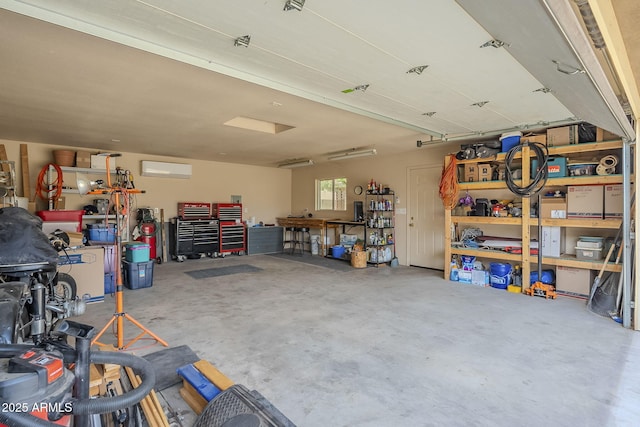 garage featuring a wall unit AC and a workshop area