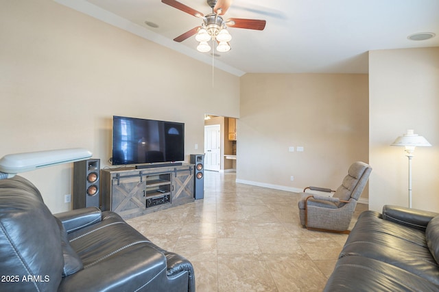 living area with vaulted ceiling, ceiling fan, and baseboards