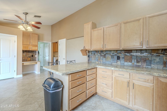 kitchen with washer / clothes dryer, visible vents, backsplash, light brown cabinets, and a peninsula