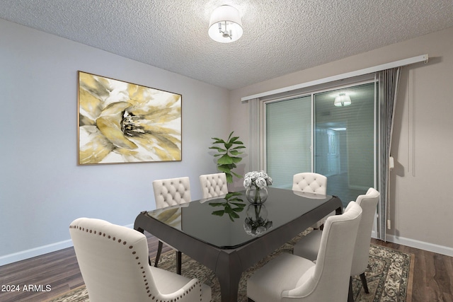 dining area with dark hardwood / wood-style flooring and a textured ceiling