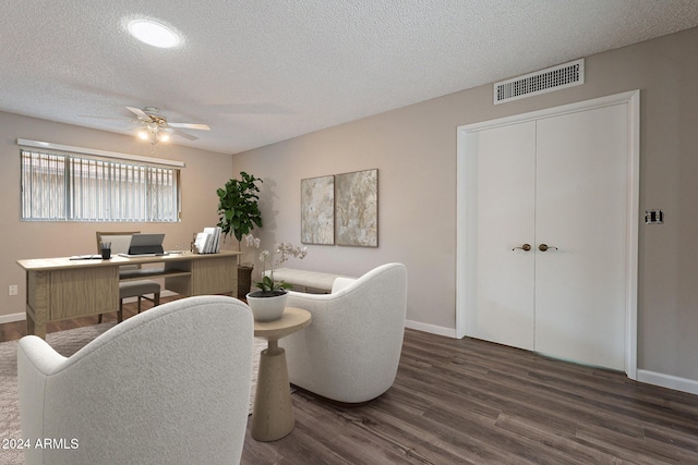 office area featuring ceiling fan, dark hardwood / wood-style flooring, and a textured ceiling