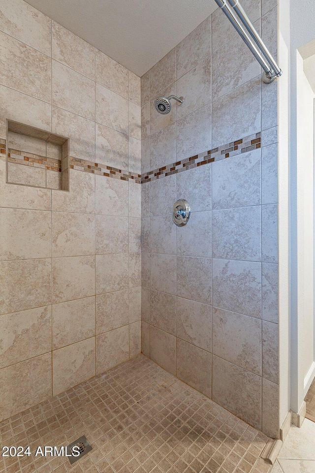 bathroom featuring a tile shower and tile patterned floors