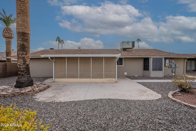 back of house with a sunroom and central AC unit