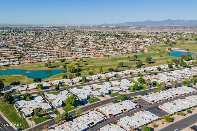 birds eye view of property with a water and mountain view