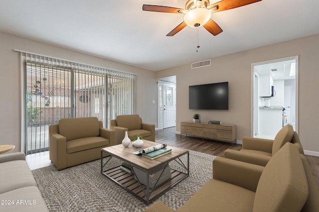 living room featuring hardwood / wood-style floors and ceiling fan