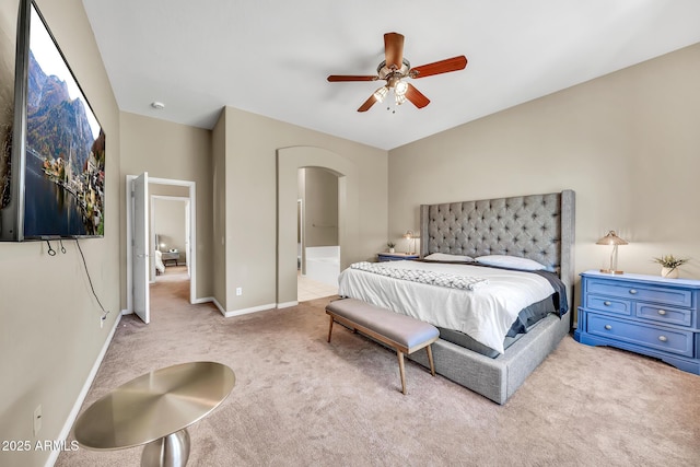 3131 E Legacy Dr Unit 1032, Phoenix, AZ 85042 - bedroom with arched walkways, carpet flooring, baseboards, ensuite bath, and ceiling fan
