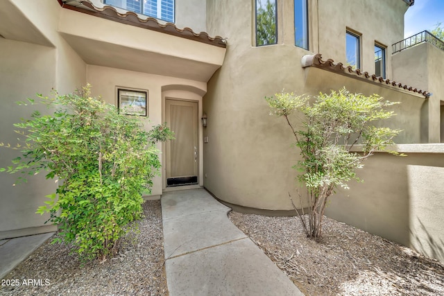 3131 E Legacy Dr Unit 1032, Phoenix, AZ 85042 - doorway to property with stucco siding and a tiled roof