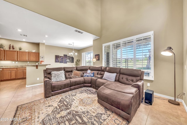 3131 E Legacy Dr Unit 1032, Phoenix, AZ 85042 - living area with light tile patterned floors, a chandelier, baseboards, a high ceiling, and recessed lighting
