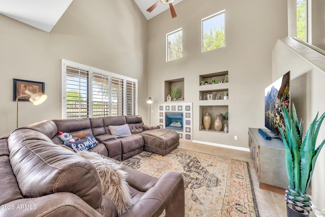 3131 E Legacy Dr Unit 1032, Phoenix, AZ 85042 - living room featuring built in features, a ceiling fan, high vaulted ceiling, light tile patterned floors, and a fireplace