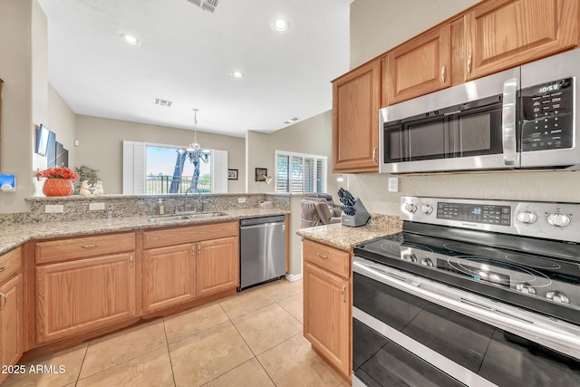 3131 E Legacy Dr Unit 1032, Phoenix, AZ 85042 - kitchen featuring appliances with stainless steel finishes, a sink, a chandelier, light stone counters, and light tile patterned flooring