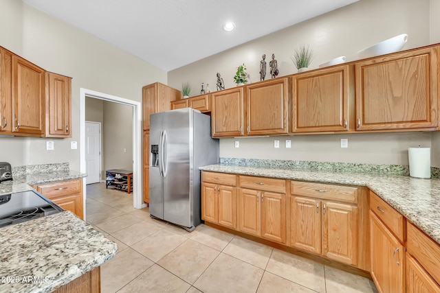 3131 E Legacy Dr Unit 1032, Phoenix, AZ 85042 - kitchen featuring stainless steel fridge with ice dispenser, light tile patterned floors, and light stone countertops
