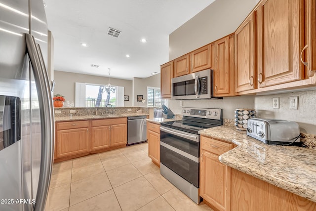 3131 E Legacy Dr Unit 1032, Phoenix, AZ 85042 - kitchen with stainless steel appliances, a sink, light tile patterned flooring, light stone countertops, and recessed lighting