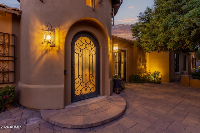 view of exterior entry at dusk