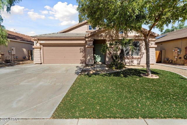 view of front of property with a front yard and a garage