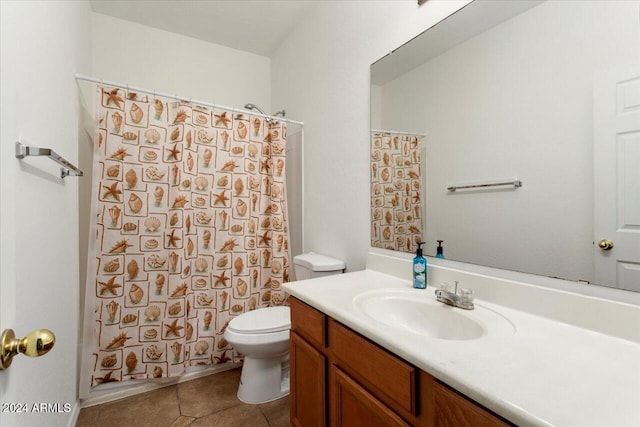 bathroom featuring curtained shower, tile patterned flooring, vanity, and toilet