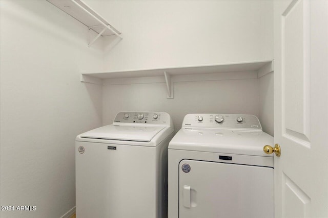 washroom featuring washer and clothes dryer