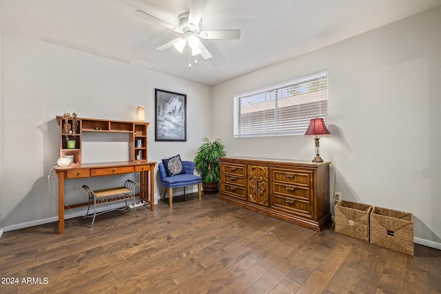 living area with ceiling fan and dark wood-type flooring