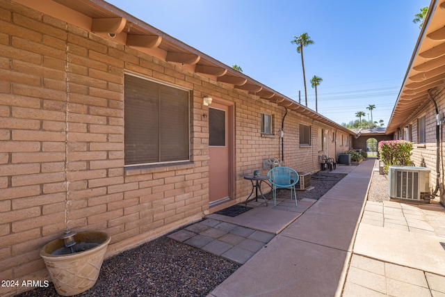 view of home's exterior with a patio area and central AC unit