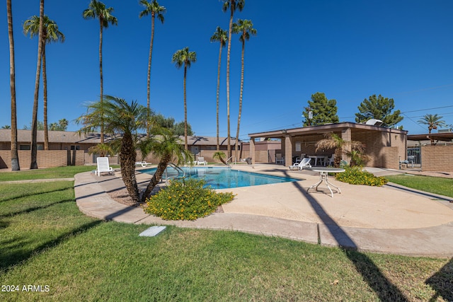 view of pool with a yard and a patio