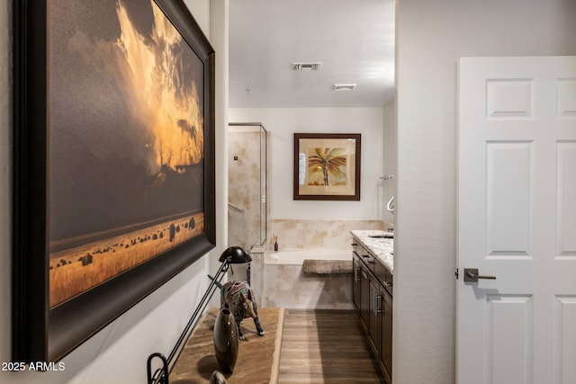 bathroom with vanity and a tub