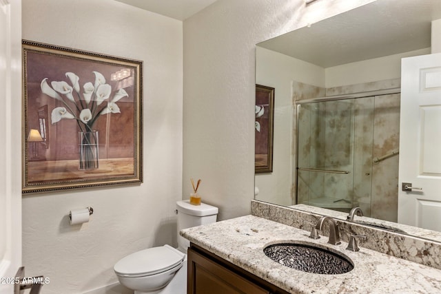 bathroom featuring walk in shower, vanity, and toilet