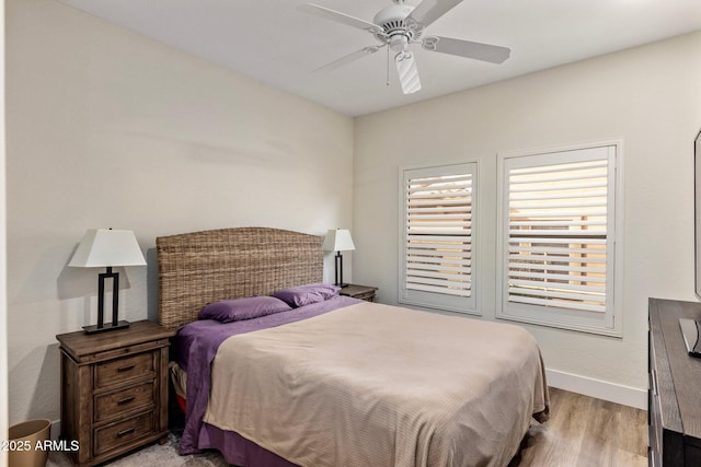 bedroom with ceiling fan and light hardwood / wood-style flooring