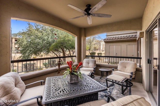 view of patio with ceiling fan and a balcony