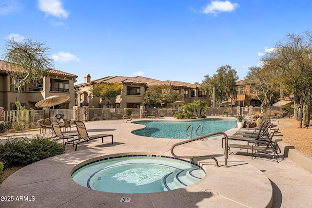 view of swimming pool with a hot tub and a patio area