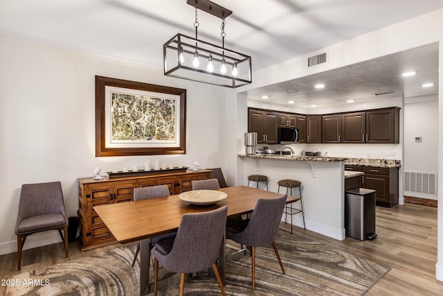 dining space featuring light hardwood / wood-style flooring